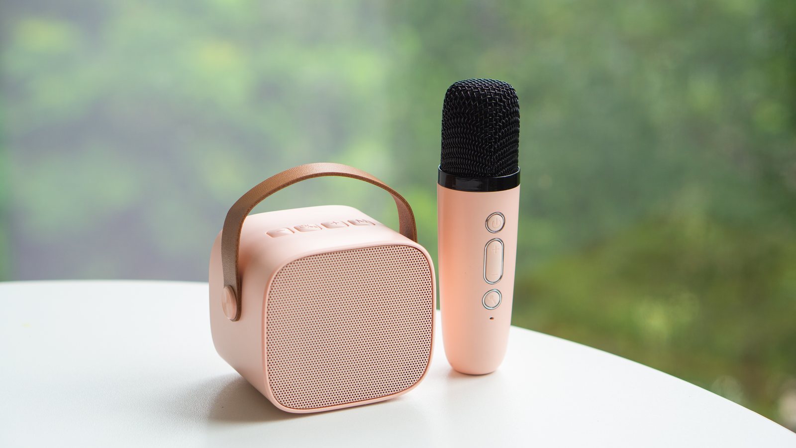 Pink YLL mini karaoke speaker with its wireless microphone